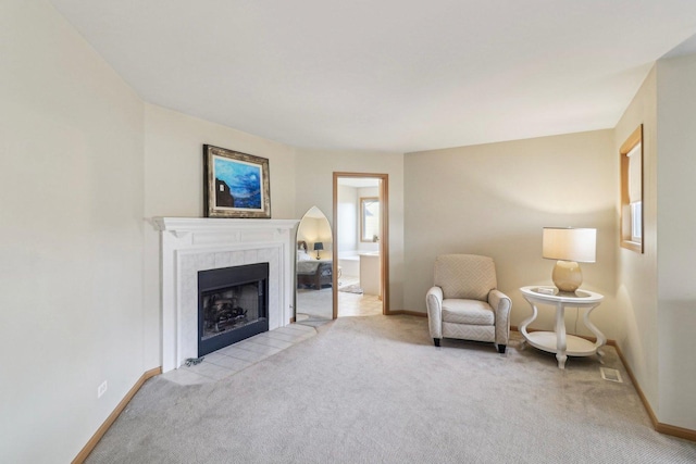 carpeted living room with a tile fireplace