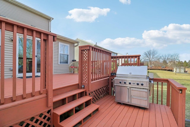 deck featuring grilling area and a yard