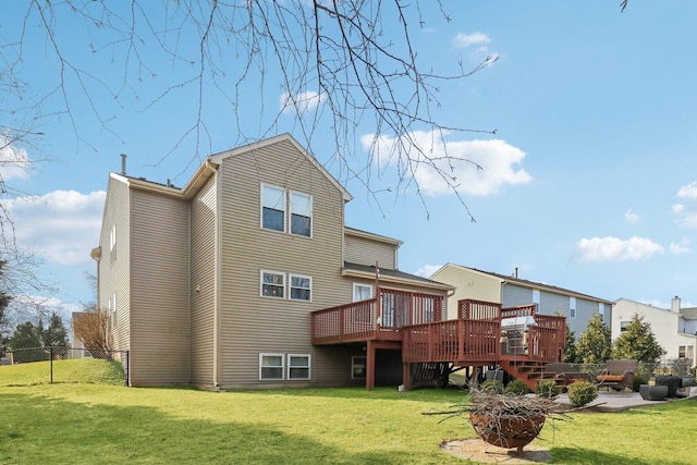 rear view of property featuring a wooden deck and a yard