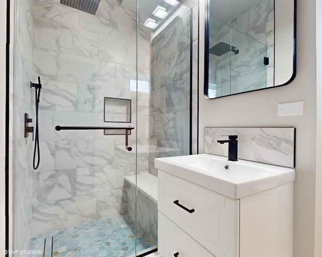 bathroom featuring vanity and a shower with door