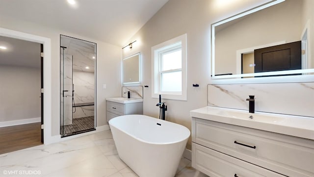 bathroom with vanity, vaulted ceiling, and independent shower and bath