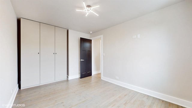 unfurnished bedroom featuring a closet and light hardwood / wood-style floors