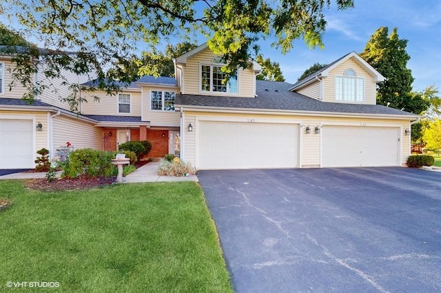 view of front property featuring a front yard and a garage