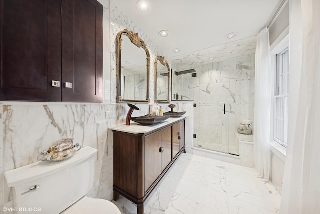 bathroom with vanity, toilet, and a shower with shower door