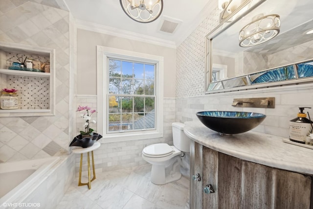 bathroom with vanity, toilet, ornamental molding, tile walls, and a chandelier