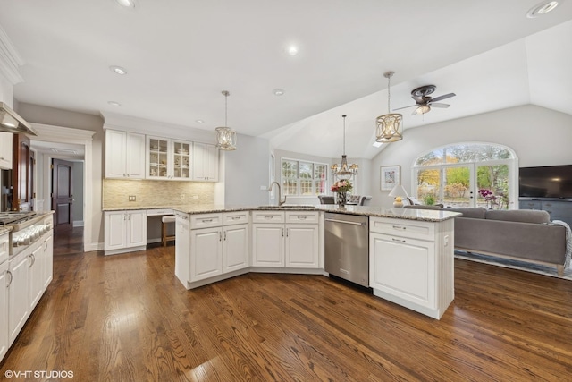 kitchen with white cabinetry, dishwasher, a kitchen island with sink, and vaulted ceiling