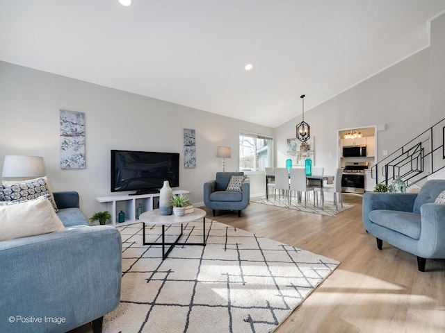 living room featuring hardwood / wood-style floors and vaulted ceiling