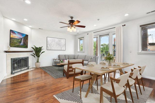 interior space featuring dark hardwood / wood-style floors, ceiling fan, and a fireplace