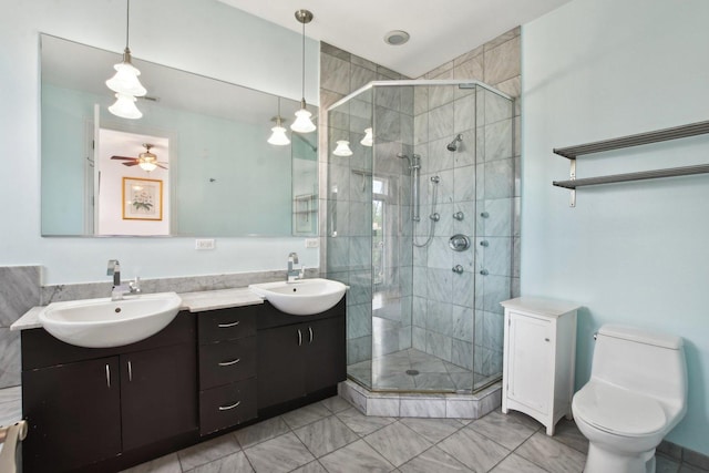 bathroom featuring ceiling fan, vanity, an enclosed shower, and toilet