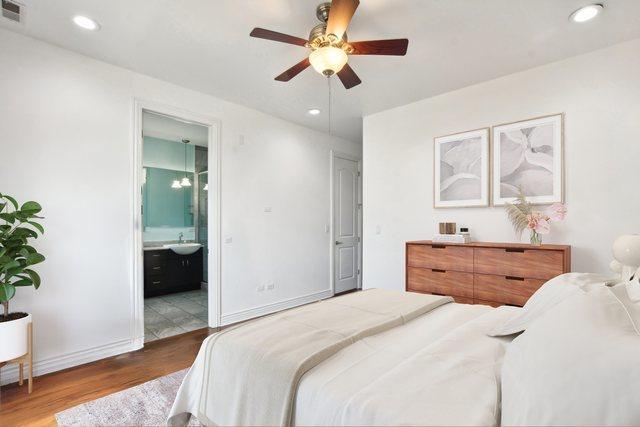 bedroom with connected bathroom, hardwood / wood-style flooring, ceiling fan, and sink