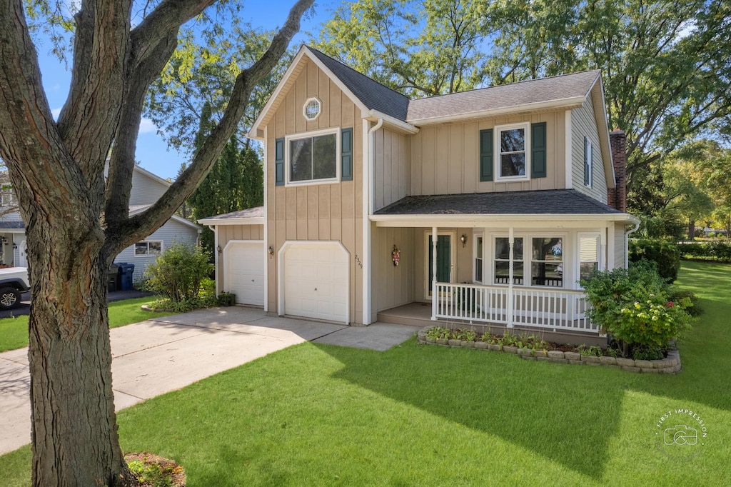 view of front facade featuring covered porch, a garage, and a front yard