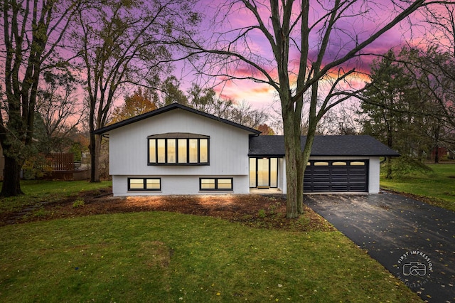 view of front facade with a yard and a garage