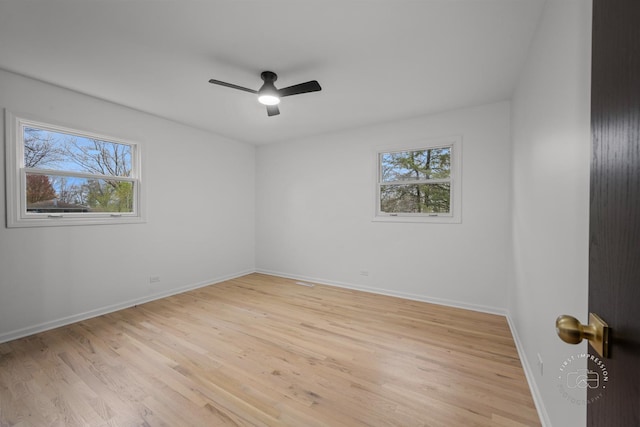 empty room featuring ceiling fan and light hardwood / wood-style flooring