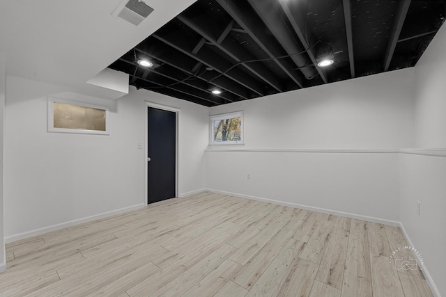 basement with light hardwood / wood-style floors