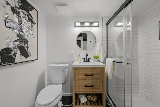 bathroom with vanity, toilet, and an enclosed shower