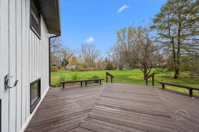 wooden deck featuring a lawn