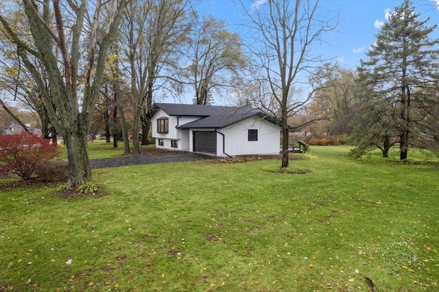 view of property exterior featuring a yard and a garage