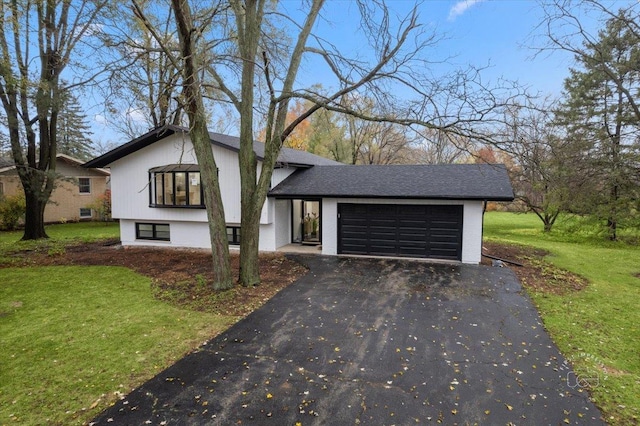 view of front of property with a front yard and a garage