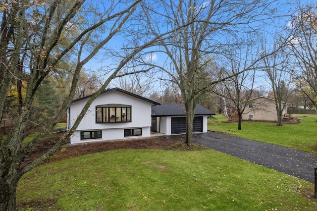 view of front of property featuring a garage and a front lawn