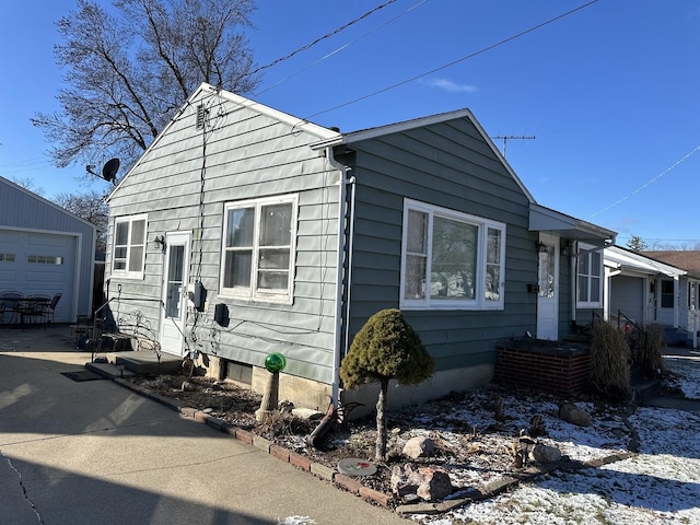 view of front of house featuring a garage and an outdoor structure