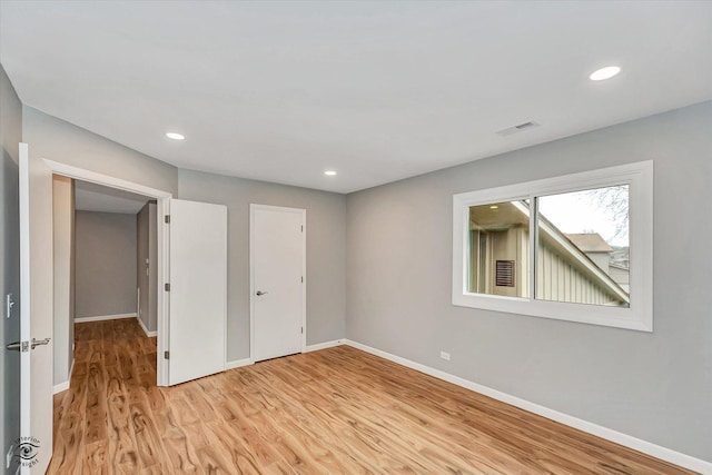 unfurnished bedroom with light wood-type flooring