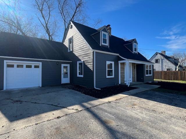 new england style home with a garage