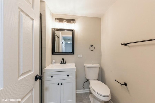 bathroom featuring tile patterned floors, vanity, and toilet