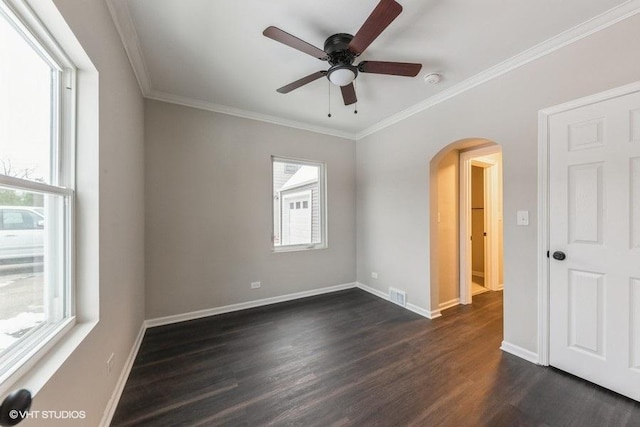 spare room with ceiling fan, crown molding, and dark wood-type flooring