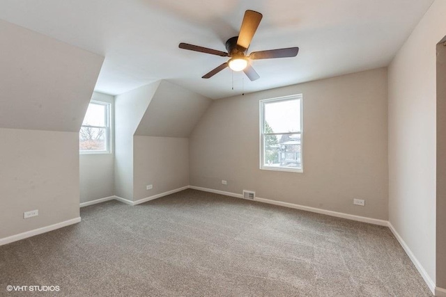 bonus room with carpet flooring, vaulted ceiling, and ceiling fan