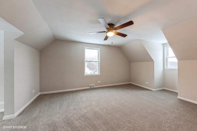 bonus room featuring light carpet, vaulted ceiling, and ceiling fan