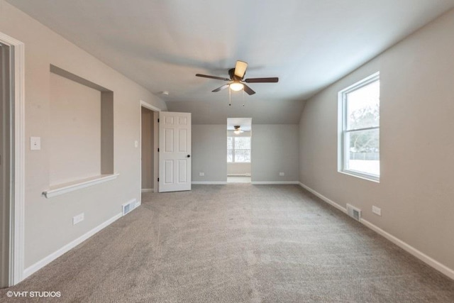 carpeted empty room with ceiling fan and vaulted ceiling