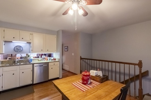 kitchen featuring ceiling fan, sink, stainless steel dishwasher, white cabinets, and light wood-type flooring