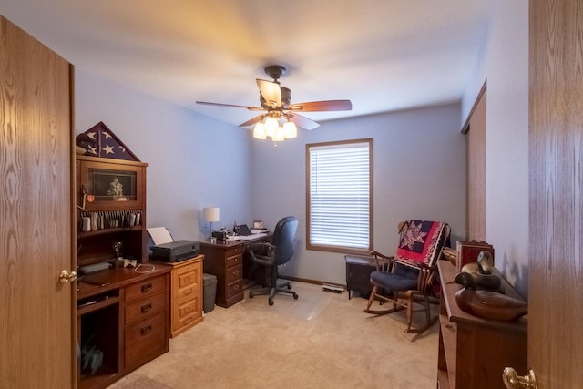 office space featuring light colored carpet and ceiling fan