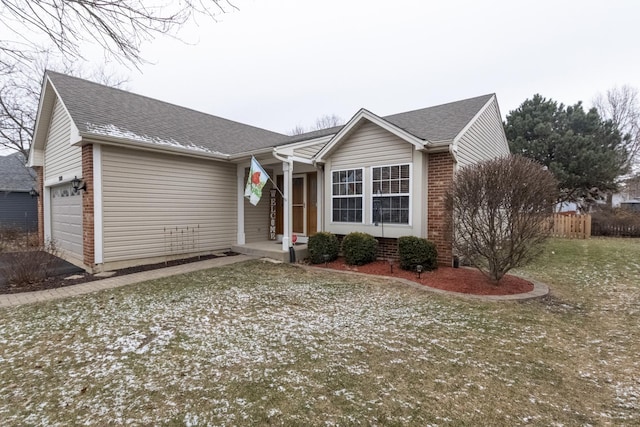 ranch-style home with a front lawn and a garage