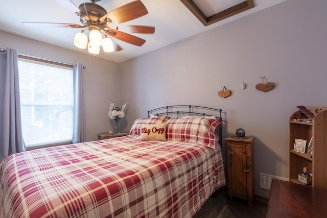 bedroom with ceiling fan and dark wood-type flooring