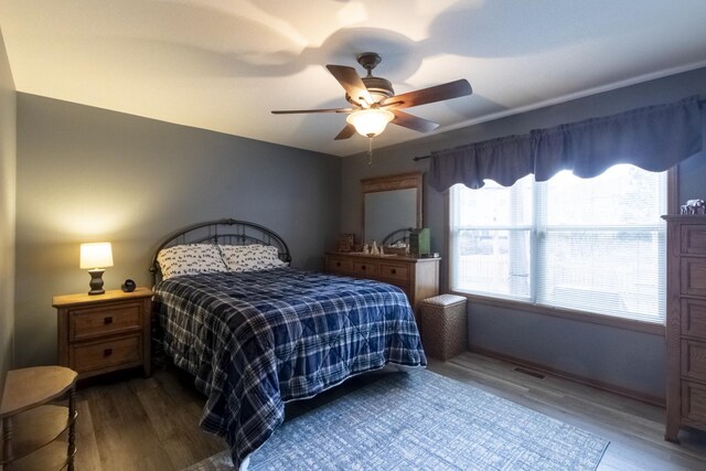 bedroom with ceiling fan and dark hardwood / wood-style flooring