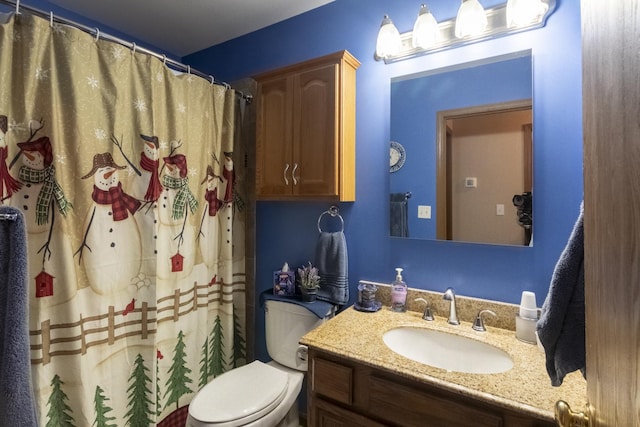 bathroom featuring vanity, curtained shower, and toilet