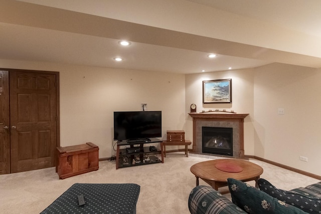 carpeted living room featuring a tile fireplace