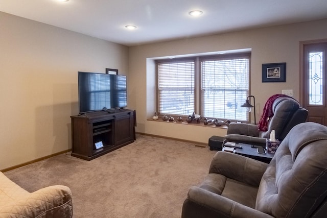 living room featuring light carpet and a healthy amount of sunlight