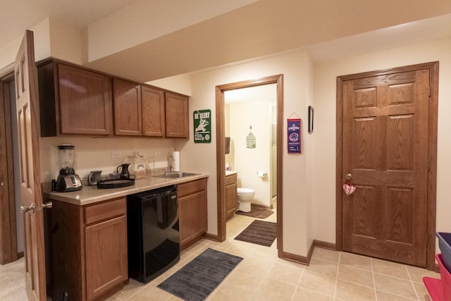 kitchen featuring dishwasher, light tile patterned flooring, and sink