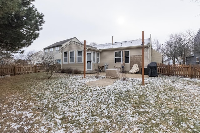 view of snow covered back of property