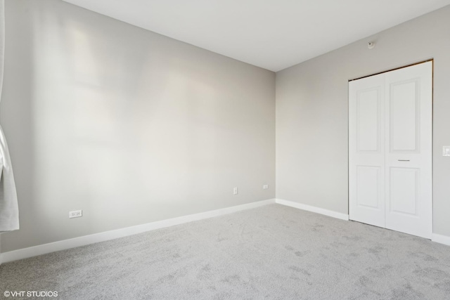 unfurnished bedroom featuring a closet and carpet flooring