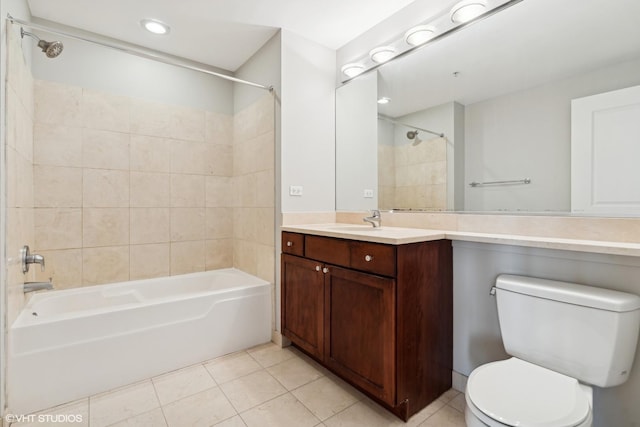 full bathroom featuring toilet, vanity, tile patterned flooring, and tiled shower / bath combo