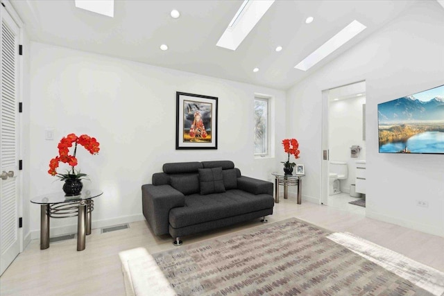 living room featuring lofted ceiling with skylight