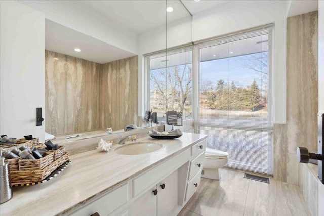 bathroom featuring vanity and toilet