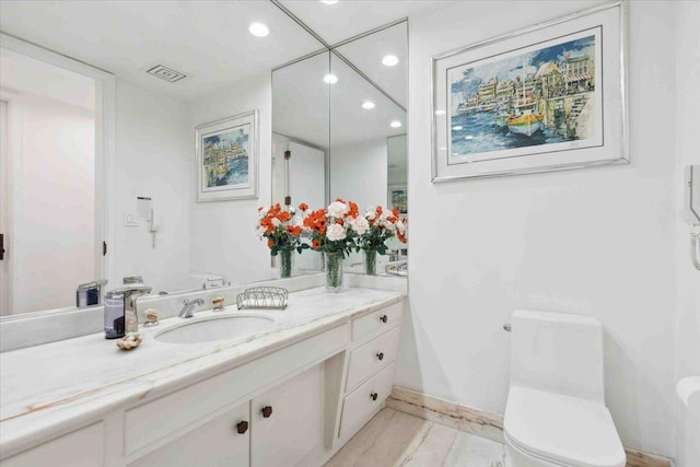 bathroom with vanity and toilet