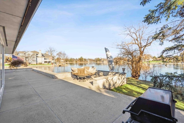 view of patio / terrace featuring a water view and a grill