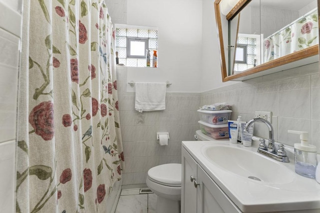 bathroom with curtained shower, plenty of natural light, and tile walls