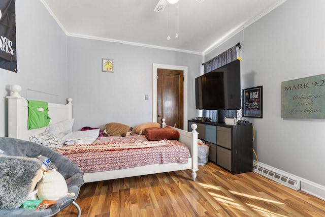 bedroom with hardwood / wood-style floors, ceiling fan, and crown molding