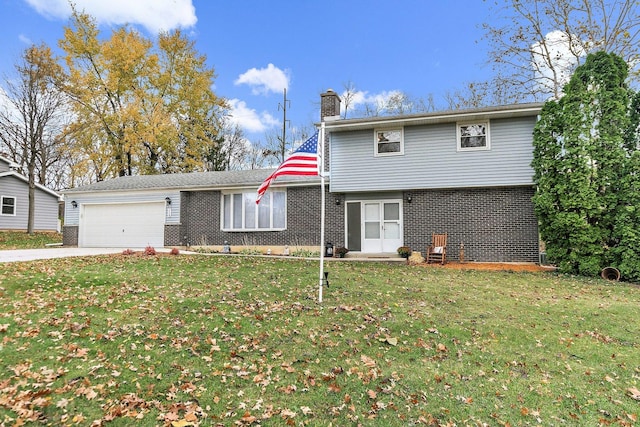 view of property featuring a garage and a front lawn